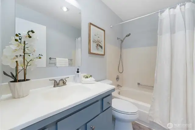 This is the full guest bathroom with tub and shower combination.  New hardware on the vanity and new showerhead as well