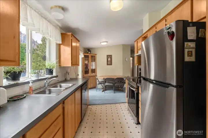 View from the kitchen into the dining area, with abundant pantry and cabinet storage