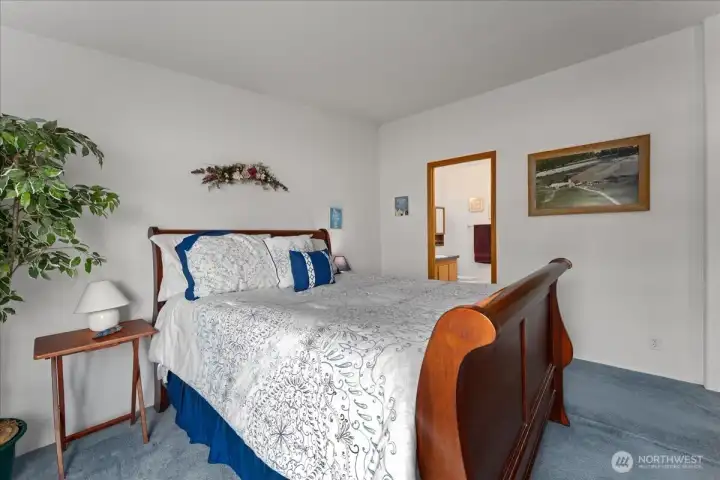 Spacious primary bedroom with an adjoining full bathroom