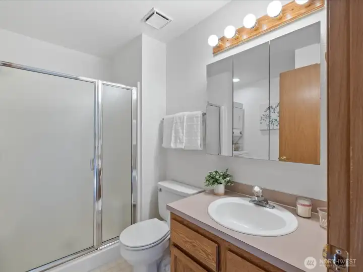 Upstairs 3/4 bathroom with stacked washer/dryer