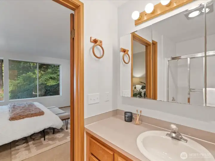 Full primary bathroom looking into bedroom