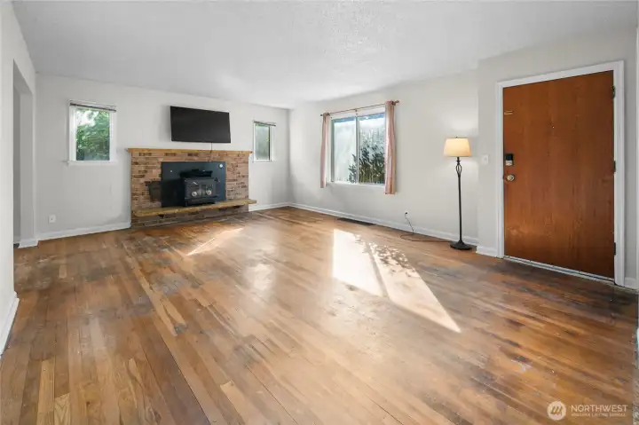Light fille living room with wood burning stove.