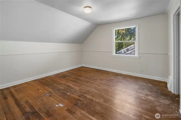 Upstairs bedroom with hardwood floors.