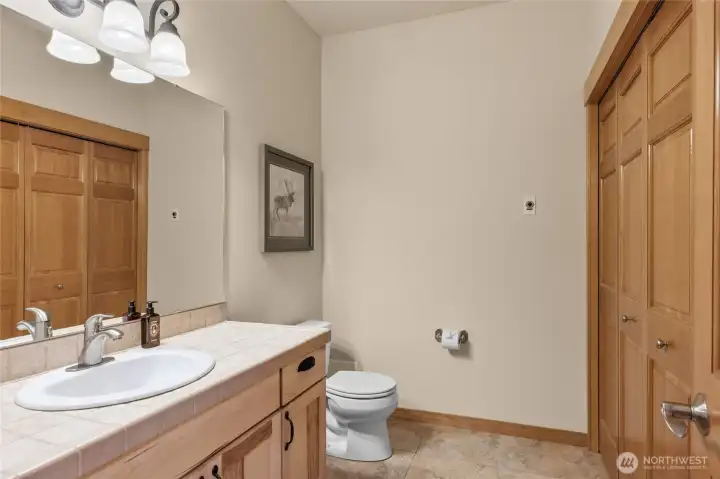 Half bath on the main level also serves as the laundry room.