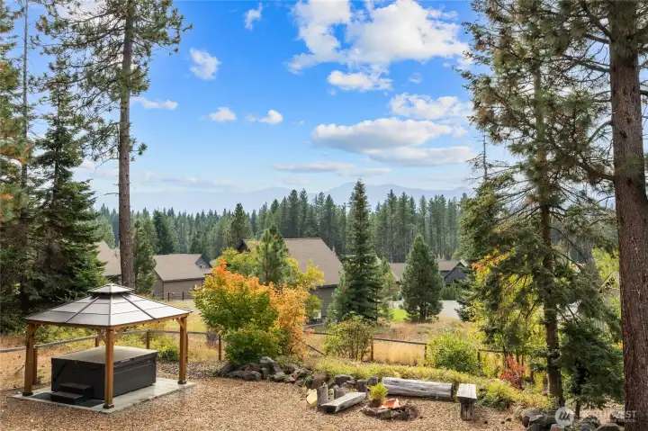 This expansive lot offers outstanding outdoor living, including a fire pit and a hot tub with a gazebo cover.