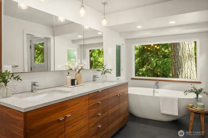 Soaking tub with forest views.