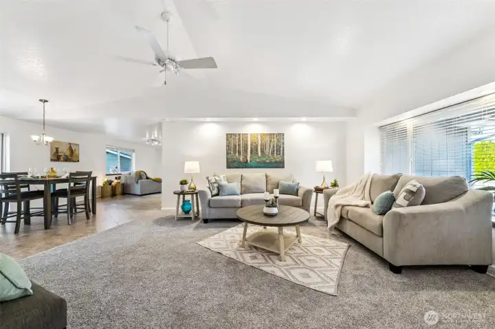 Gorgeous, brand new carpet warms the great room space.  The large picture window, with window seat, is lit by recessed lighting as is the extra wide art wall. Most of the home's windows include white faux wood blinds.