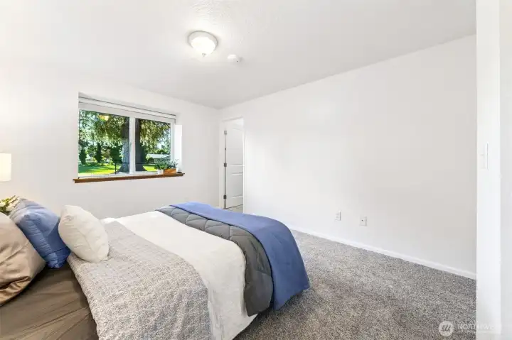 The freshly painted walls and new white trim work and doors in the primary bedroom are ready for your favorite bedroom decor and personal touch. The pewter-toned, new carpet offers a soft flooring for your night time tootsies.