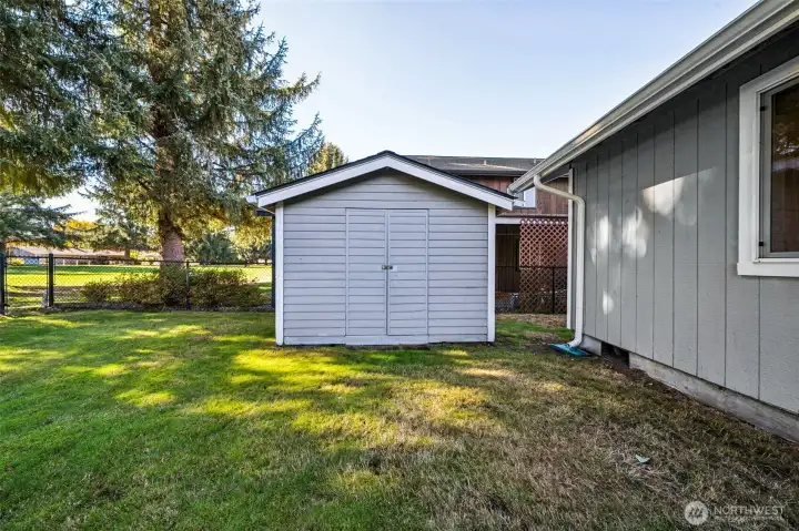 The large garden and lawn tool shed is accessed by the RV parking area and door from the side of the garage.  It also provides a convenient privacy feature between the homes.
