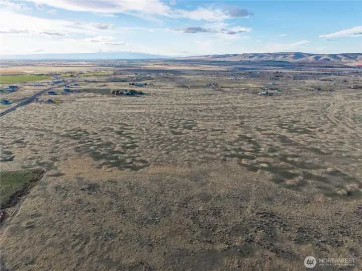 Photo is from the east looking west. The southeast corner is near the squared-off green area on the left. You can draw a straight line through the middle of the photo, northward. Road 10.8 is on the left edge of the photo with no access.