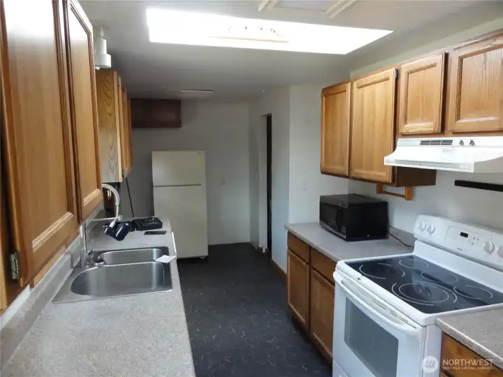 Huge kitchen with plenty of counter tops and cabinets.