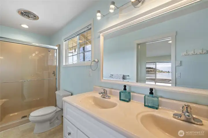 Primary with double vanity and large step in shower.