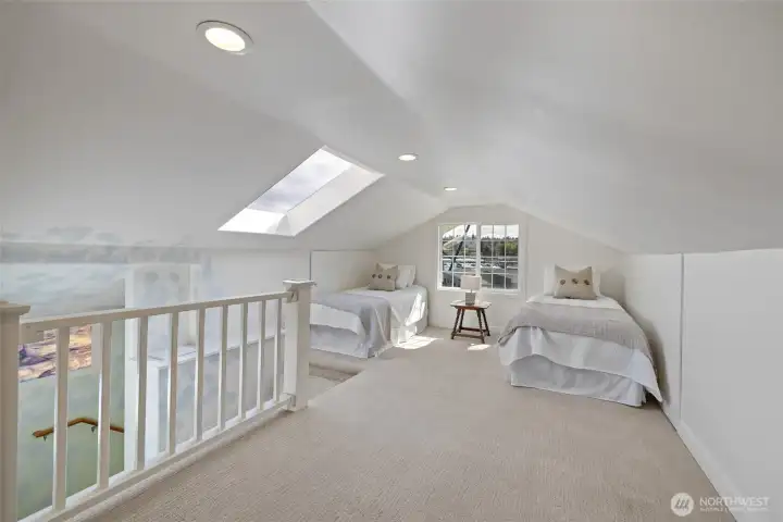 Upstairs you will find a spacious open room staged as a bedroom & office.