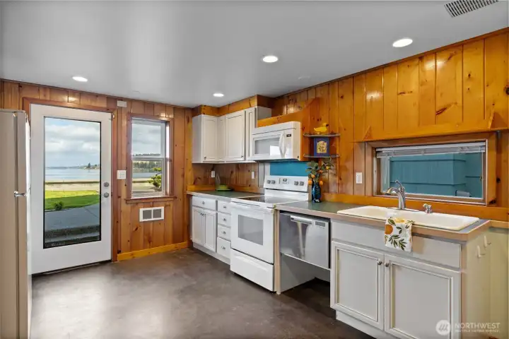 Full kitchen continues with the knotty pine wood work.