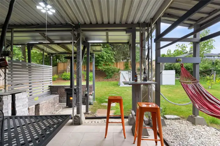 covered back patio with built in patio heater and bbq area
