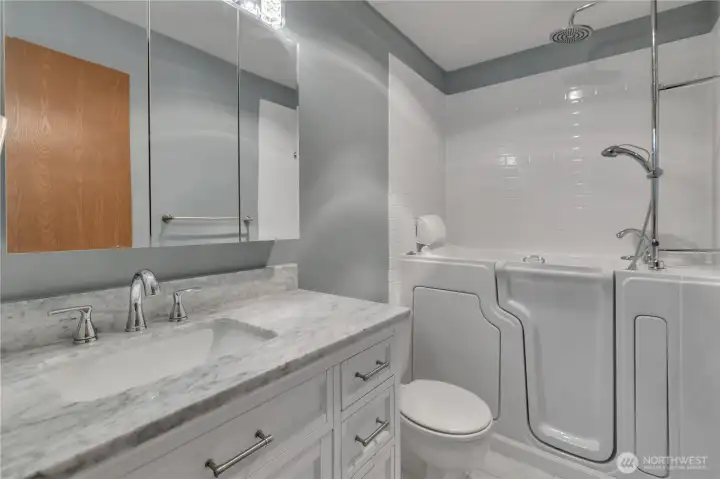 Primary bath with soaking walk in tub and shower