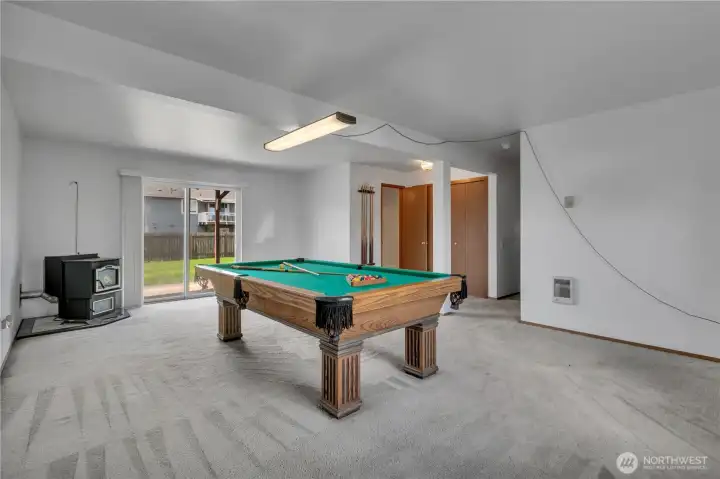 Recreation room with pellet stove and area with utility closet