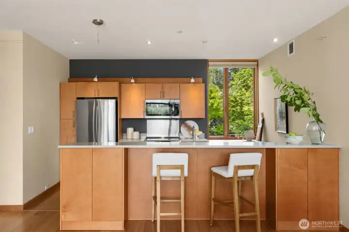 Completely open kitchens were all the rage for a while, until we tired of looking at our cooking mess while trying to relax over dinner. Enter the bar-height seating and storage peninsula, concealing the countertops while also providing useful space for serving and displaying art objects.