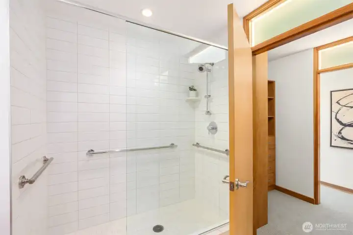 The oversized low-clearance shower’s classic subway tile will never be dated. Tasteful grab bars can be useful at any age and stage of life.