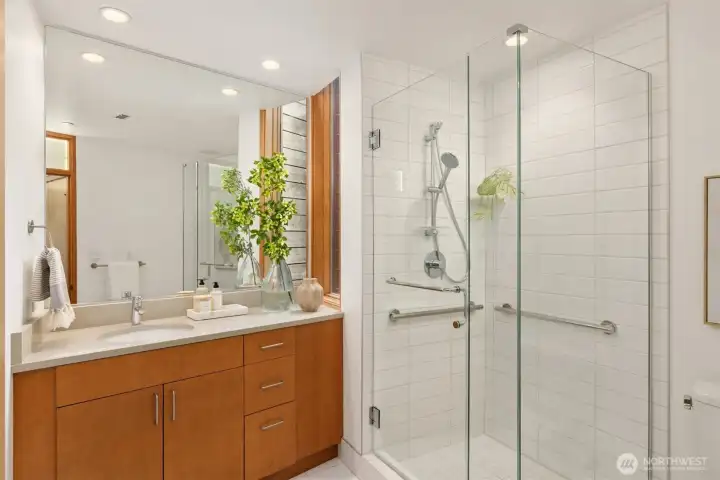 The 2nd en suite bathroom features the same timeless design elements as the primary, and also hides linen storage behind the door into the bedroom. A second door from the hallway allow it to function as the powder room for daytime and dinner guests, as well.