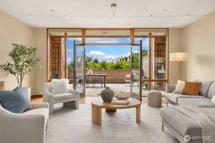 Such pleasing symmetry! Note the covered area just outside the French doors that offers a bit of shelter as well as two architecturally-interesting and handy alcoves – ideal for your grill, a potting table, dry storage, or seating when you prefer to sit out of the sun (or drizzle…this is the PNW).