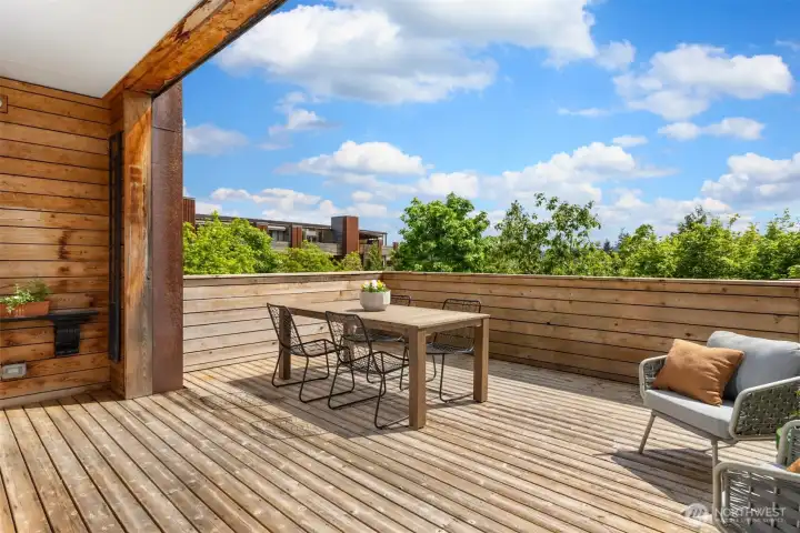 The generous deck can accommodate lounging, dining, large planters, and more. Perhaps even a hammock for the lazy days of summer?