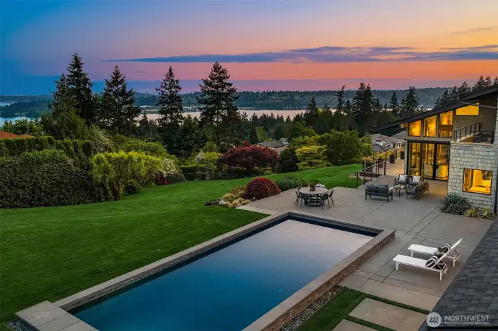 In ground pool surrounded by tiered patios and handsome hardscape