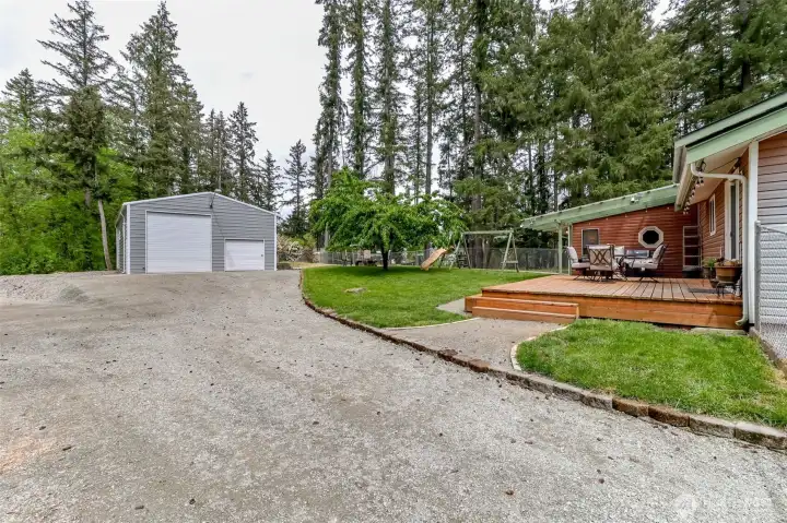 Exceptional development of this lot from clearing trees to yard and lot development and the addition of the custom shop with RV roll up door and RV hook up.