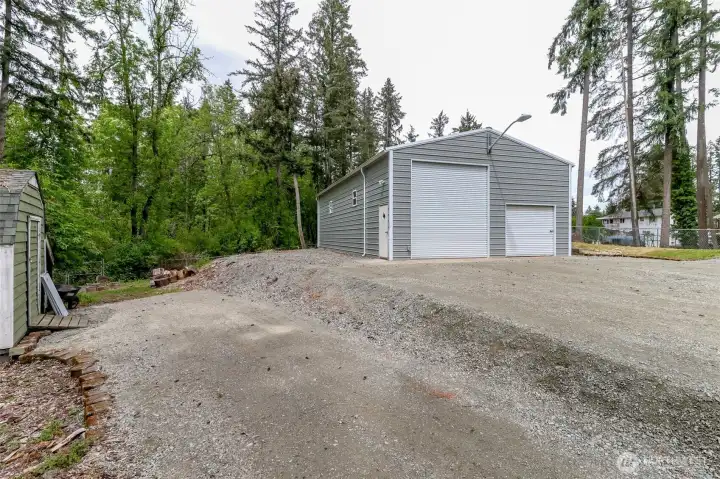 Two outbuildings and large chicken coop to the left of this picture.  Shop has flood and motion lights. Security system and roll up RV door.