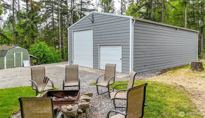 Fire pit faces the shop and second outbuilding storage.