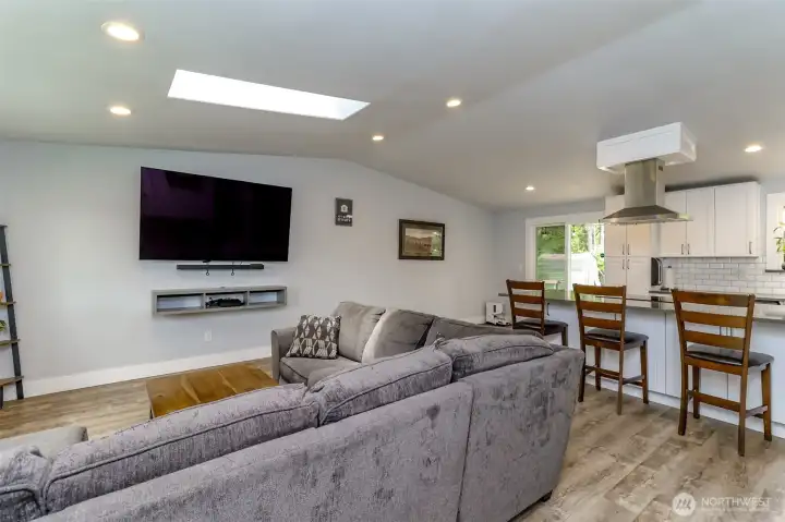 This view is just off the front door and is of the living room and fully remodeled kitchen.