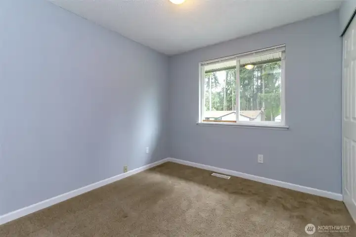Extra bedroom overlooking the backyard.