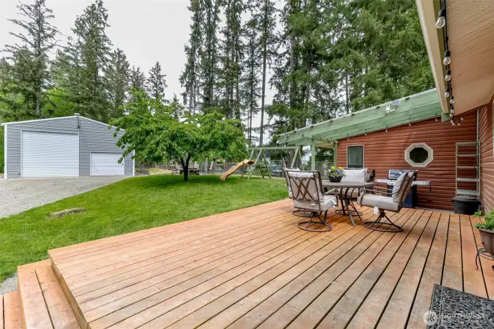 Spacious deck off of kitchen and dining room overlooking the backyard.