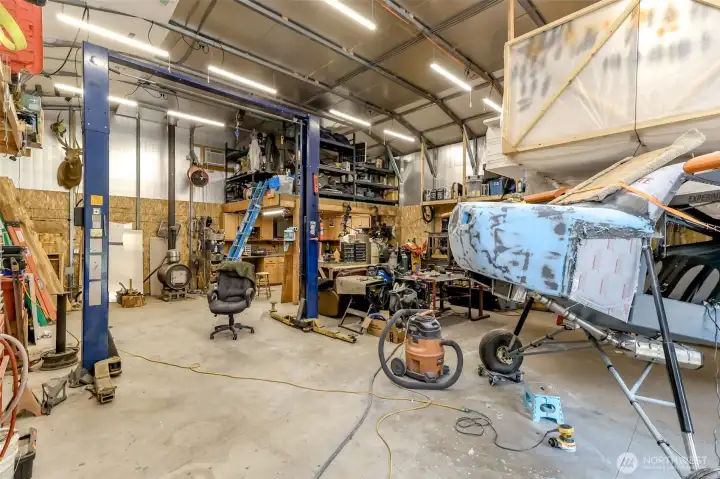 Car lift stays, loft storage in the back corner and all storage shelving stays. Shop has RV plug in, security system, motion and flood lights, Each wall wired to separate breakers.