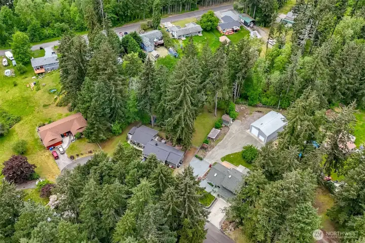 The property extends back behind the shop and beyond the fence.