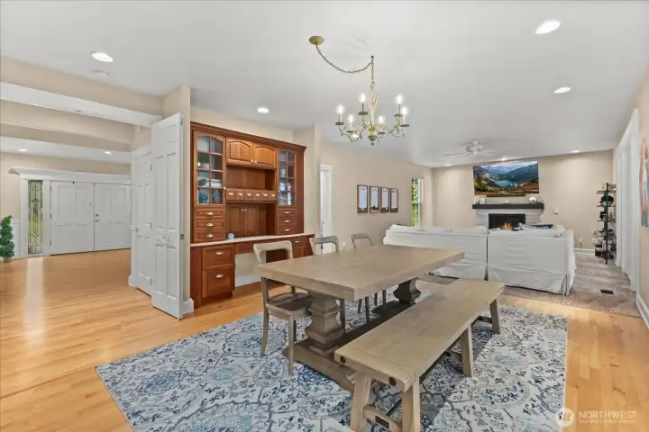 Seamless sightline from dining area to front door, highlighting built-in workspace and storage hutch