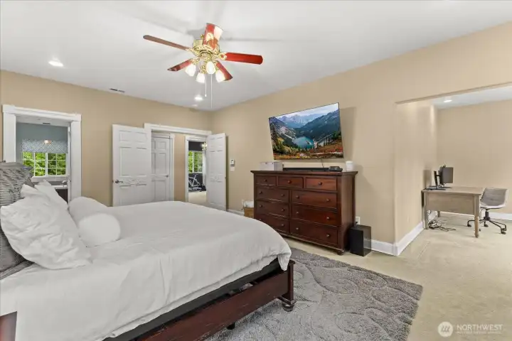 Primary suite featuring a large bedroom that flows into a private sitting room and deck