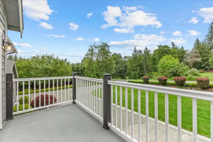 Expansive deck off primary bedroom overlooking peaceful and private acreage surroundings