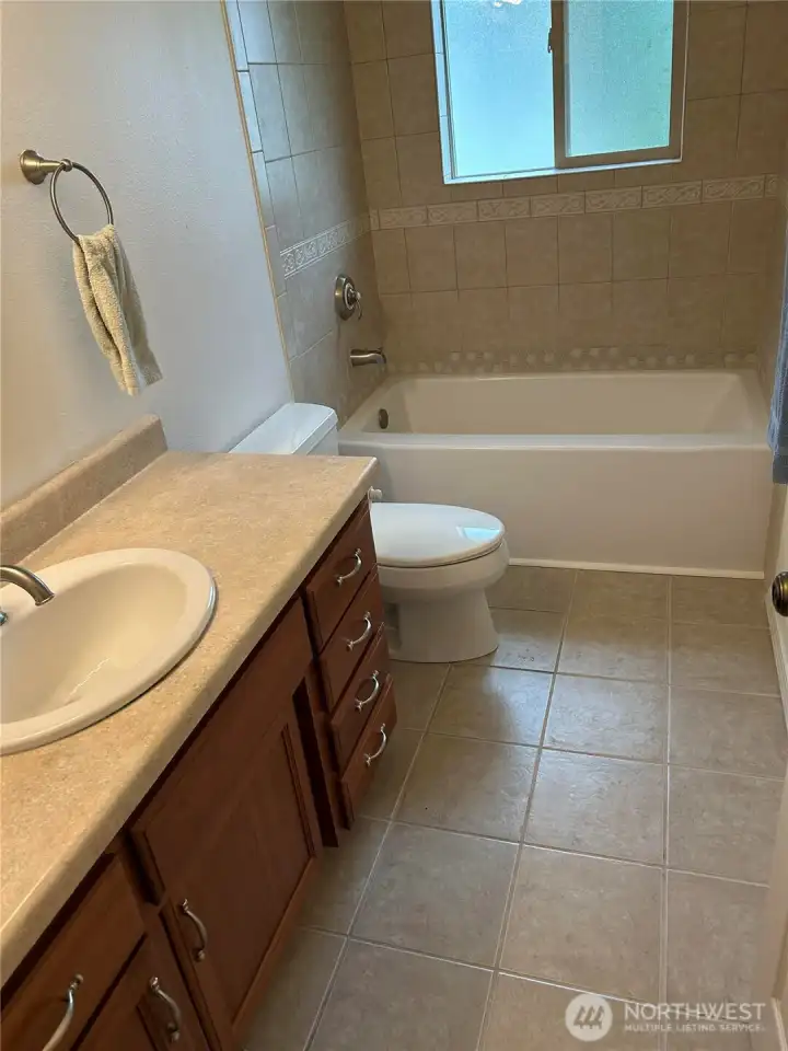The main bath has been updated with a new tub and tile surround.  The owner insisted that it be corrected before coming on the market.