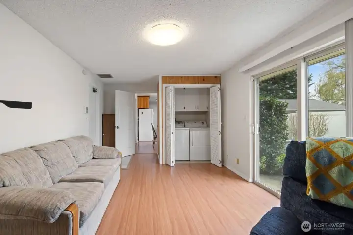 In the entertainment room, the laundry area is shielded with bifold doors yet close enough for the job to always get done.