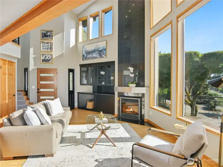 Grand, open living space where soaring ceilings and a statement fireplace create an unforgettable first impression