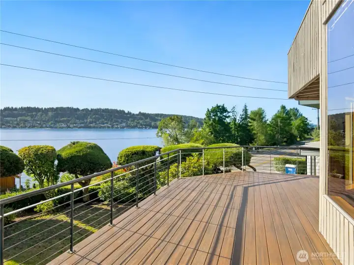 French doors open onto a generous wraparound deck offering front-row seats to stunning Lake Washington sunsets and the serene Kennydale shoreline