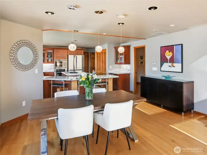 Casual dining area anchored by warm hardwood floors and an easy, open connection to the living spaces