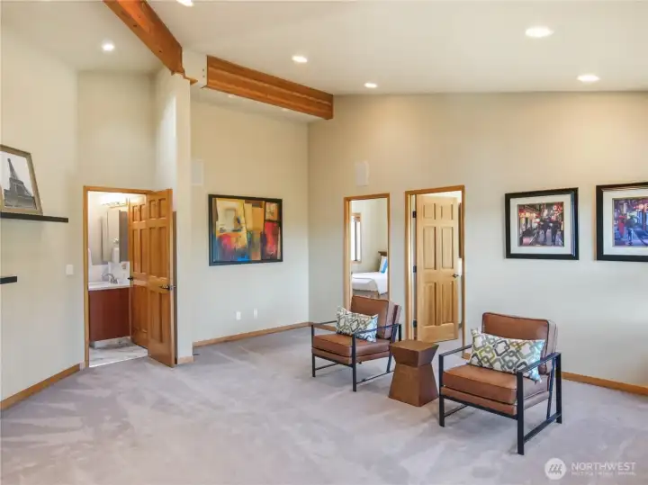 Set apart in a private wing, this flexible bonus room bridges two bedrooms.