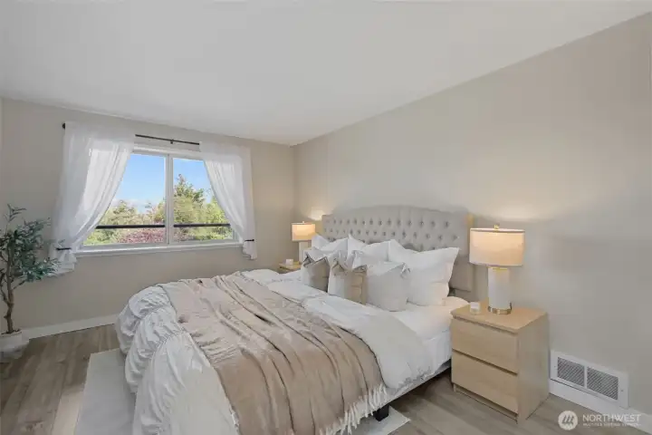 Primary bedroom is spacious enough to comfortably fit a king sized bed