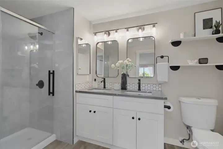 Completely updated bathroom with chic lighting, tile and matte black finishes