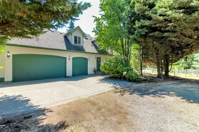 Three car garage and back entry door into the utility room that leads to a 3/4 bath on main floor at back of the house. Perfect location after a long day of working outside.