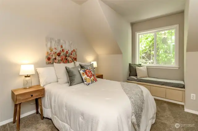 Upstairs extra bedroom with storage in the window seat. This bedroom also has a walk in closet. Make sure you check out the additional storage door in this closet that leads to tons of extra unfinished storage.