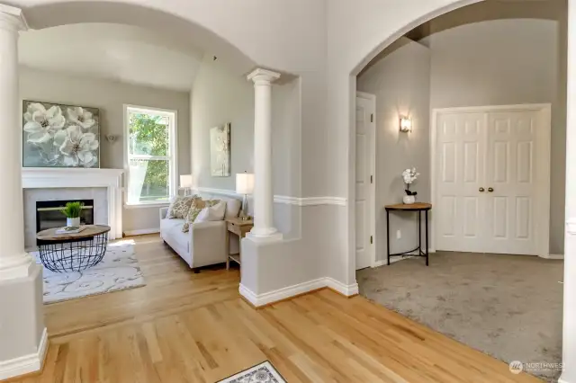 This picture was taken from the entry and faces the formal living room with propane fireplace. The French doors to the right lead to the primary bedroom. Gorgeous oak floors on the main floor.