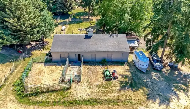 Aerial view of the North side of the barn with paddocks. Full vehicle turn around and view of the chicken coop at the back of the barn.